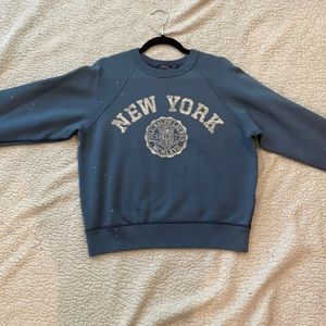 A blue Polo Shirt with New York written on it.